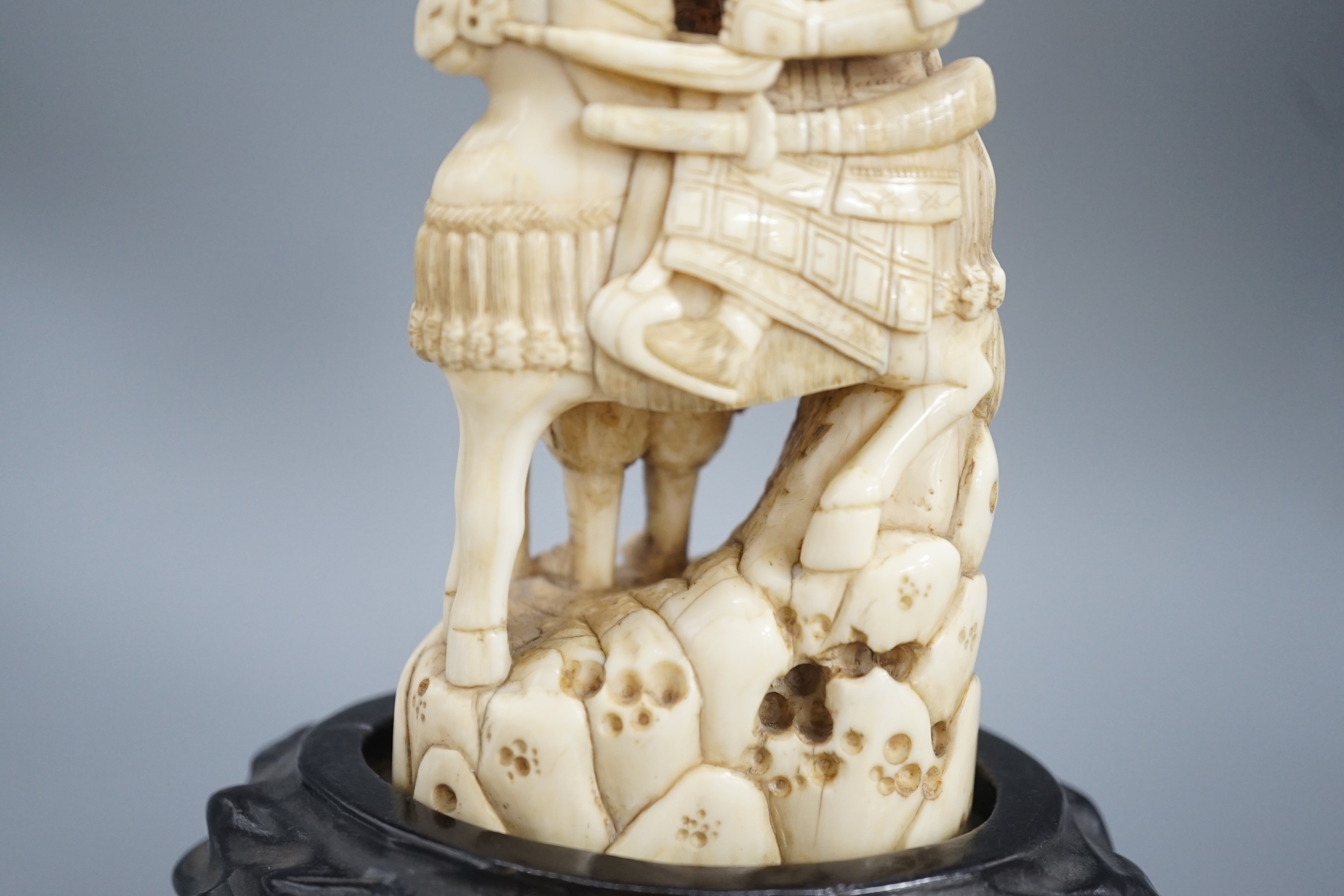A Japanese ivory okimono of a samurai on horseback, with an attendant behind him, signed, late 19th century 12cm